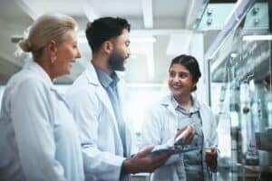 meeting,,glass,wall,and,team,of,scientists,in,lab,for