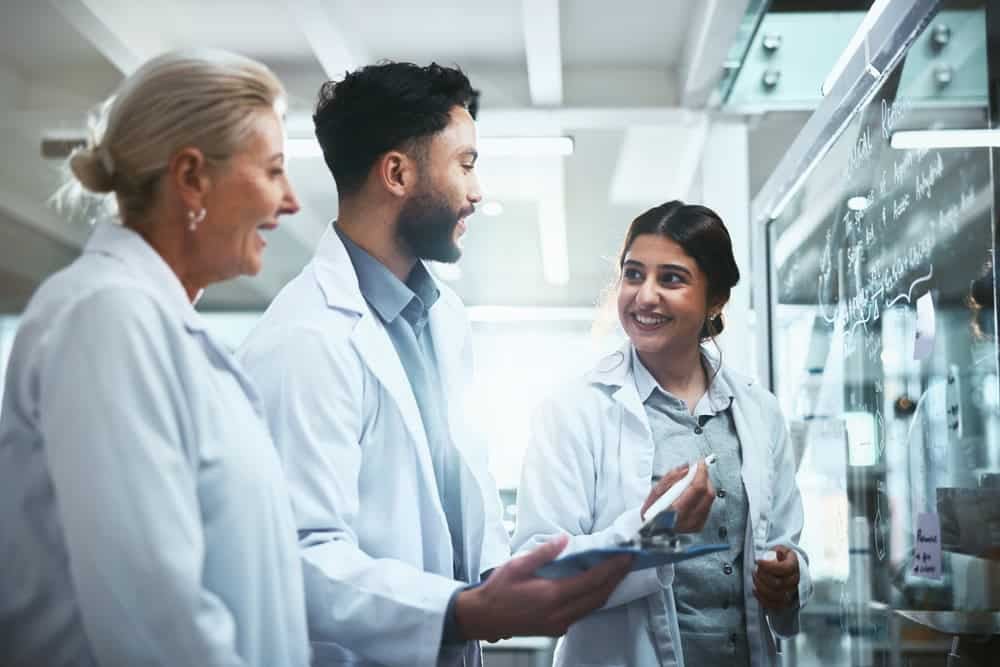meeting,,glass,wall,and,team,of,scientists,in,lab,for